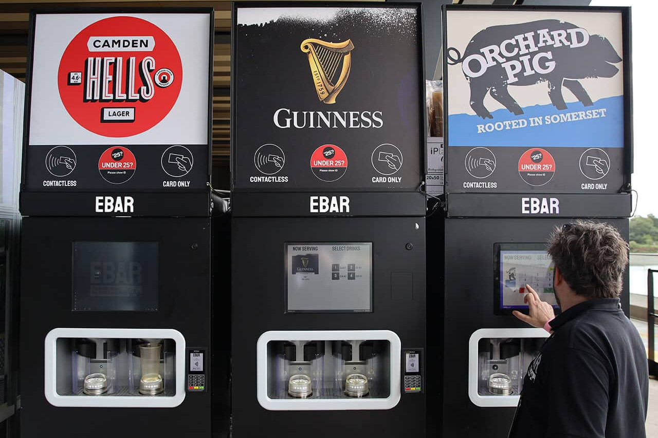 An EBar technician uses a touchscreen to test one of the three mobile EBar units he has just set up