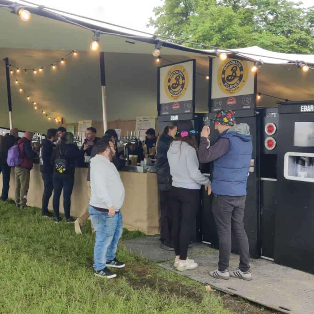 A pop up bar at a greenfield festival, with three mobile EBar units helping to keep the queues down
