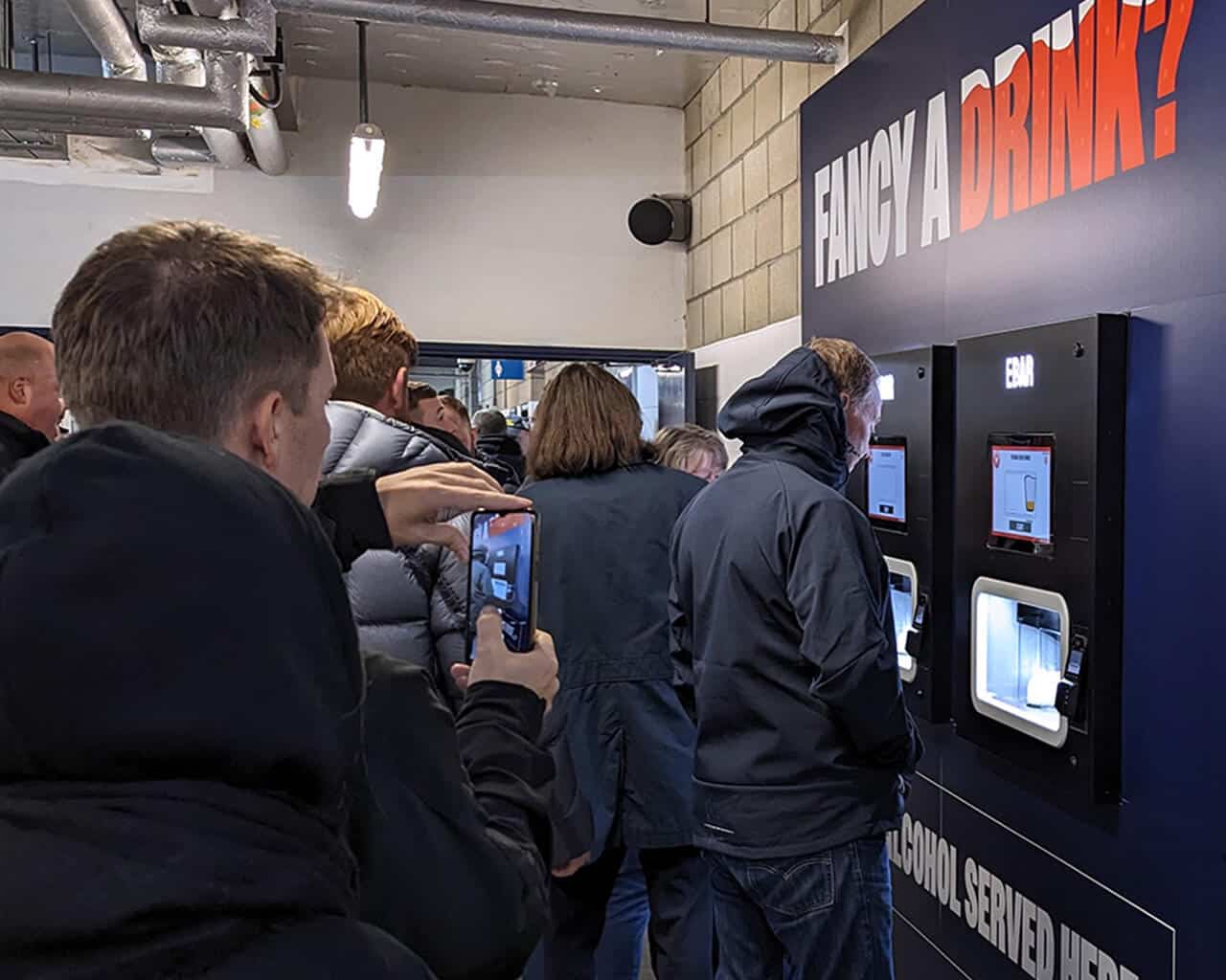 Fans making use of a club-branded 2-unit Beerwall at The Den, Millwall FC