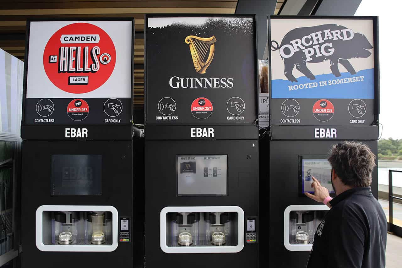 An EBar technician uses a touchscreen to test one of the three mobile EBar units he has just set up